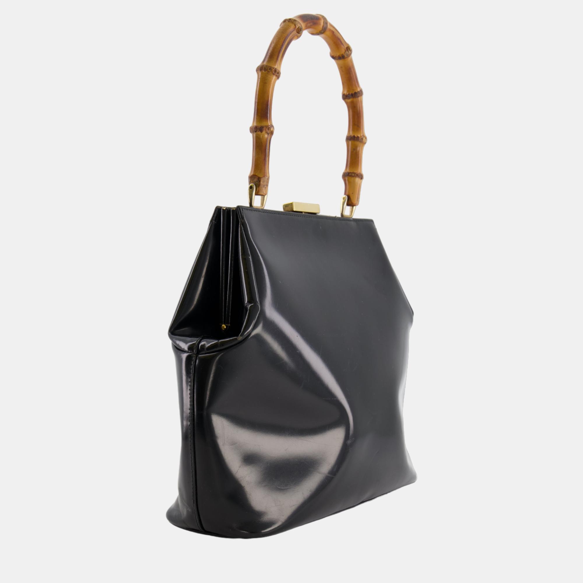 Gucci Vintage Black Patent Leather Bag with Bamboo Handle and Gold Hardware
Gucci Vintage Black Patent Leather Bag with Bamboo Handle and Gold Hardware