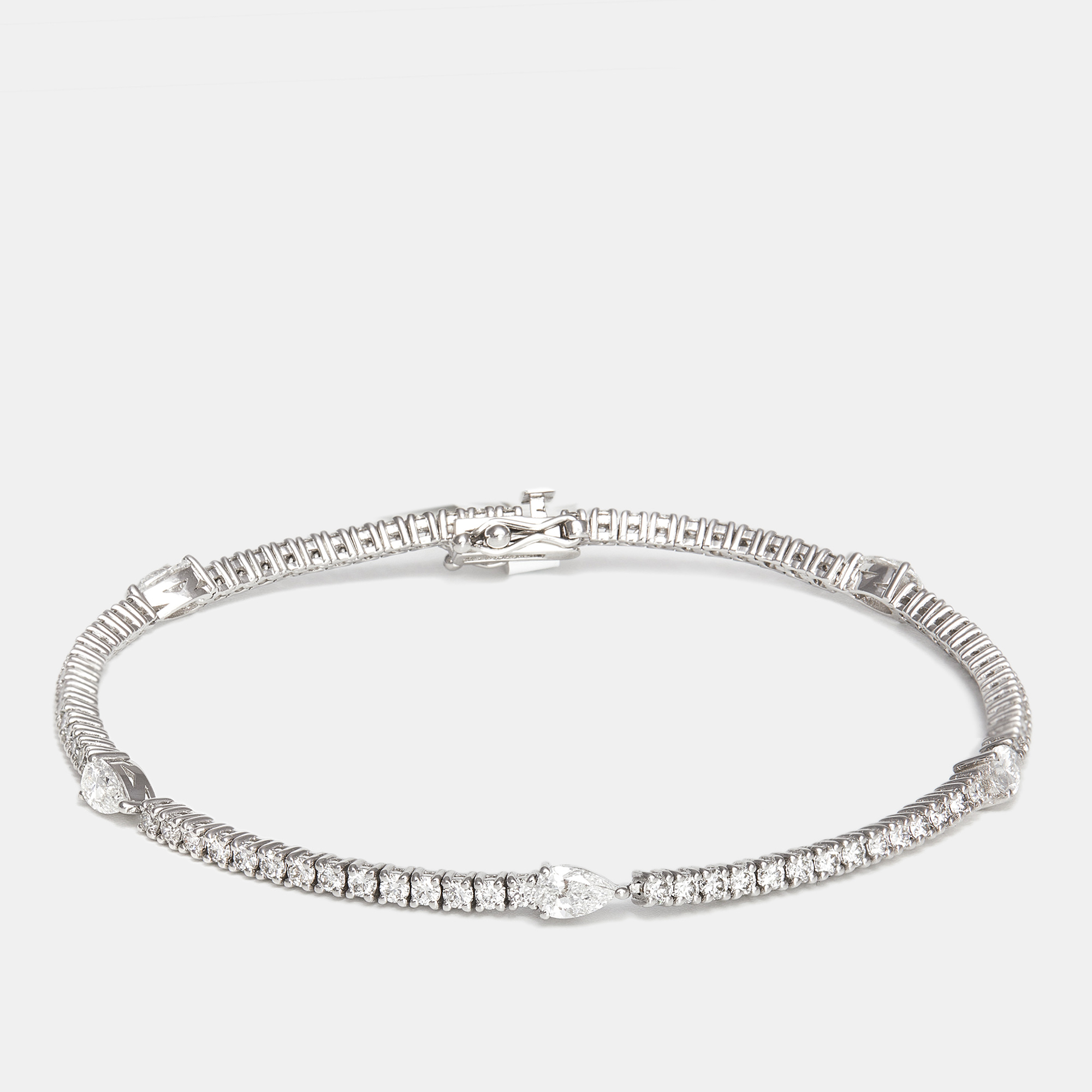 The diamond edit 18k white gold pear shape and round diamonds 2.62 cts elegant tennis bracelet