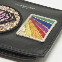 مملوكة مسبقًا محفظة بطيتيين سان لوران بقع جلد أسود