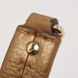 Pre Owned Carolina Herrera Gold Monogram Embossed Leather Bow Bucket Hobo