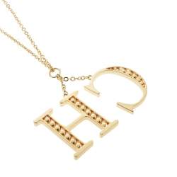 Pre Owned CH Carolina Herrera Faux Pearl Logo Charm Gold Tone Long Pendant Necklace