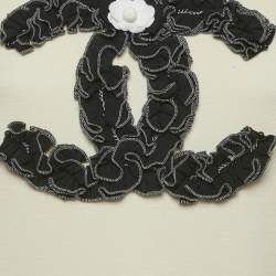 مملوكة مسبقًا توب شانيل جيرسي كريمي بكشكشة مقاس متوسط (ميديم)