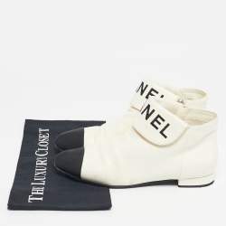 Pre Owned Chanel Ivory/Black Leather Logo Cap Toe Ankle Length Boots Size 38.5