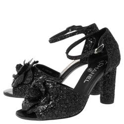 مملوكة مسبقًا صندل شانيل سير كاحل كاميليا غليتر أسود مقاس 38