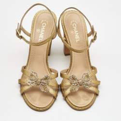 Pre Owned Chanel Gold Textured Leather Crystal Embellished Bow Ankle Strap Sandals Size 37.5