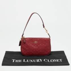 Pre Owned حقيبة صغيرة كوتش نوليتا جلد محفور بتوقيع باللون الأحمر