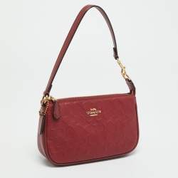 Pre Owned حقيبة صغيرة كوتش نوليتا جلد محفور بتوقيع باللون الأحمر