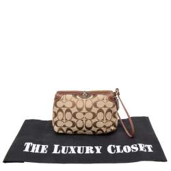 Pre Owned Coach Brown/Beige Signature Canvas and Leather Turnlock Wristlet Pouch