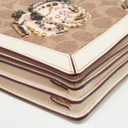 Pre Owned Coach Beoge/Old Rose Signature Coated Canvas and Leather Rose Embellished Riley Crossbody Bag