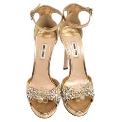 مملوكة مسبقًا صندل ميو ميو جلد ذهبي مزخرف بحزام للكاحل نعل سميك مقاس 39