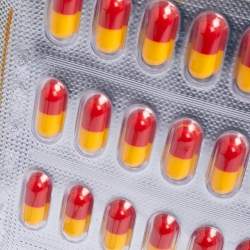 Pre Owned Moschino Silver Leather And PVC Pill Blister Wristlet Clutch