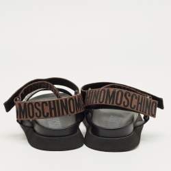 Pre Owned Moschino Brown/Black Canvas Logo Ankle Strap Flat Sandals Size 37