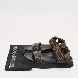 Pre Owned Moschino Brown/Black Canvas Logo Ankle Strap Flat Sandals Size 37