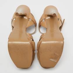 مملوكة مسبقًا صندل سان لوران تريبوت جلد بيج لامع نعل سميك مقاس 36.5