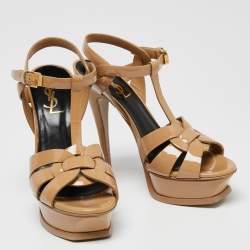 مملوكة مسبقًا صندل سان لوران تريبوت جلد بيج لامع نعل سميك مقاس 36.5