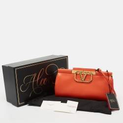 Pre Owned Valentino Orange Leather Rockstud Logo Plaque Clutch