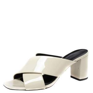 مملوكة مسبقًا صندل سلايد سان لوران لولو جلد لامع كريمي سيور متعاكسة مقاس 37