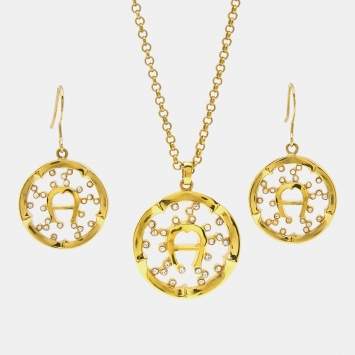 Pre Owned Aigner Gold Tone Crystal Embedded Logo Pendant Necklace & Earrings Set