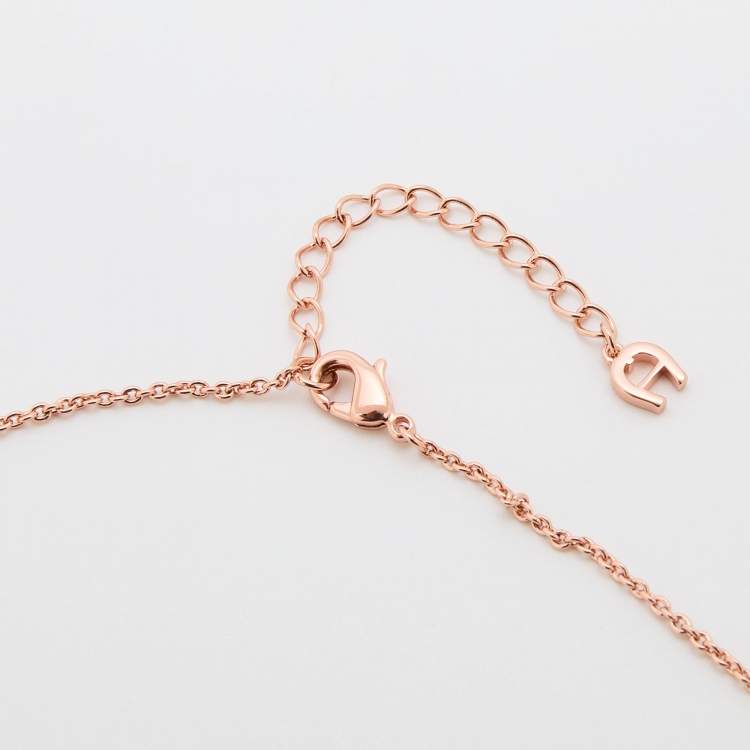 Pre Owned Aigner Rose Gold Tone Crystal & Mother of Pearl Logo Pendant Necklace