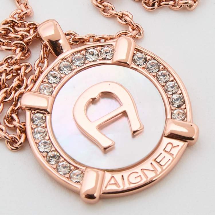 Pre Owned Aigner Rose Gold Tone Crystal & Mother of Pearl Logo Pendant Necklace