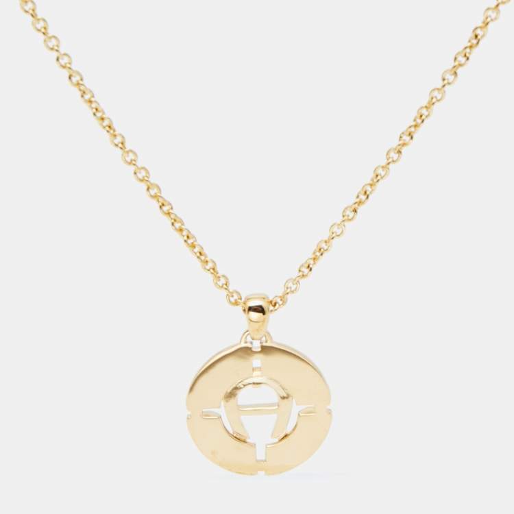 Pre Owned Aigner Gold Tone Mother of Pearl Crystal Logo Earring & Necklace Set