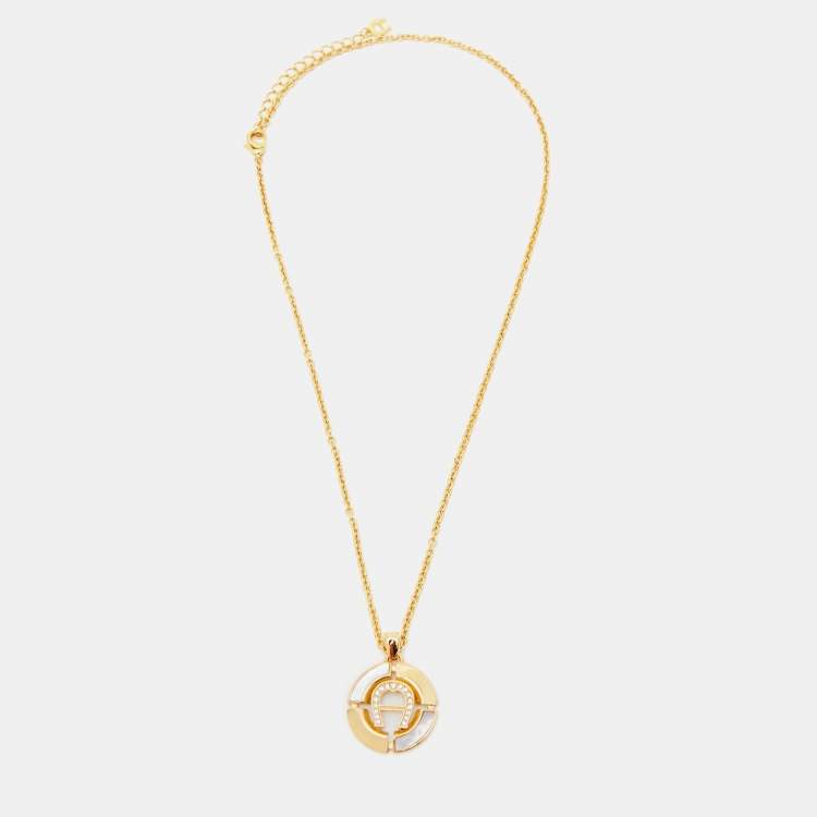 Pre Owned Aigner Gold Tone Mother of Pearl Crystal Logo Earring & Necklace Set