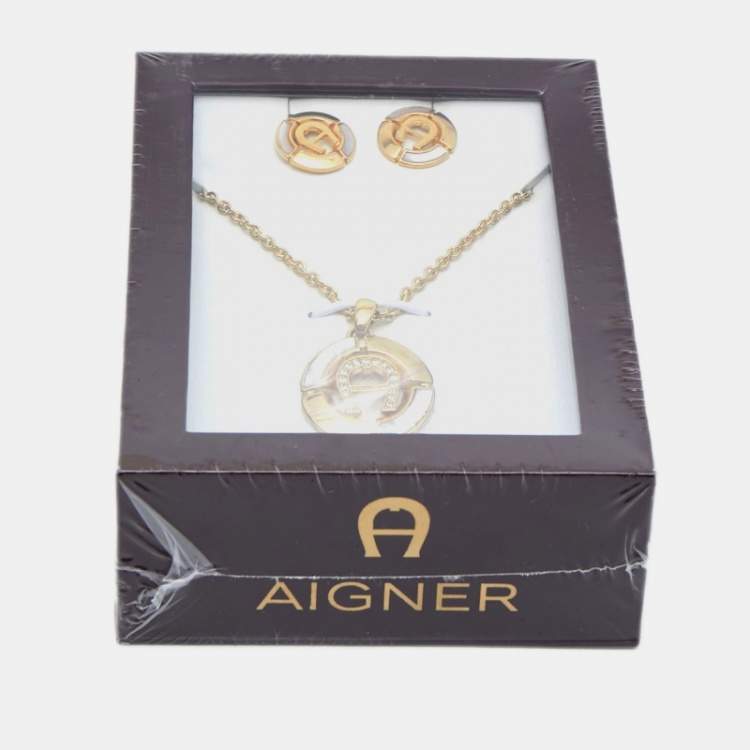Pre Owned Aigner Gold Tone Mother of Pearl Crystal Logo Earring & Necklace Set