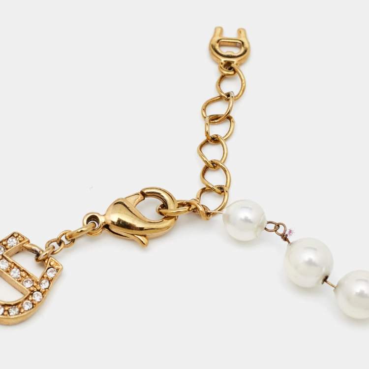 Pre Owned Aigner Gold Tone Crystal Logo Faux Pearl Station Bracelet