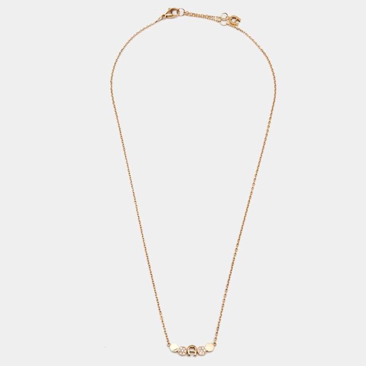 Pre Owned Aigner Crystal Logo Gold Tone Bracelet Earring and Necklace Set