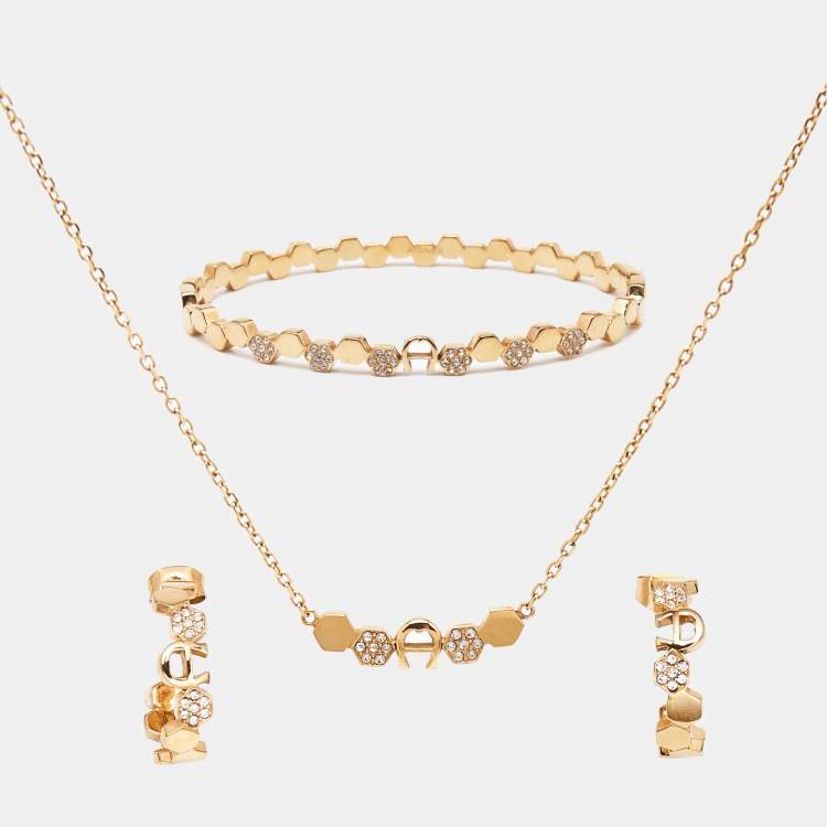 Pre Owned Aigner Crystal Logo Gold Tone Bracelet Earring and Necklace Set