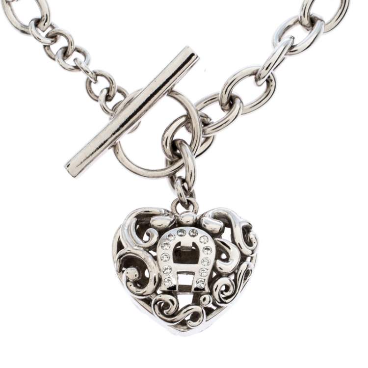 Pre Owned Aigner Silver Plated Crystal Cutwork Heart Charm Toggle Bracelet
