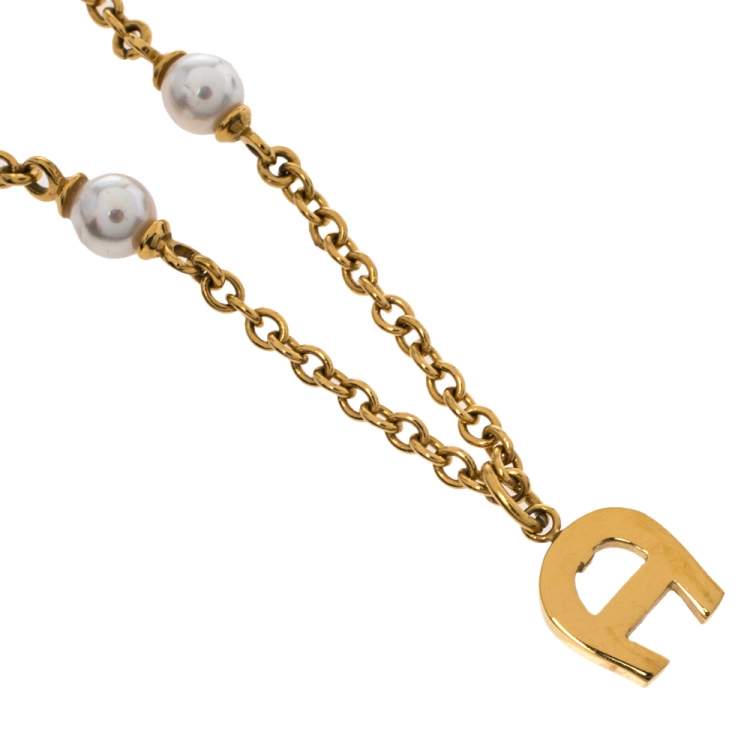 Pre Owned Aigner Crystal Logo Gold Tone Necklace and Earrings Set