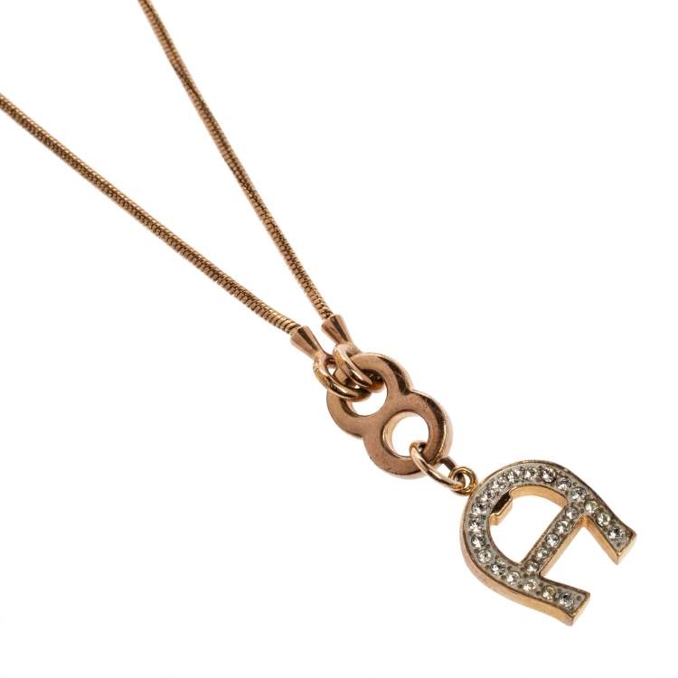 Pre Owned Aigner Gold Tone Crystal Logo Pendant Necklace