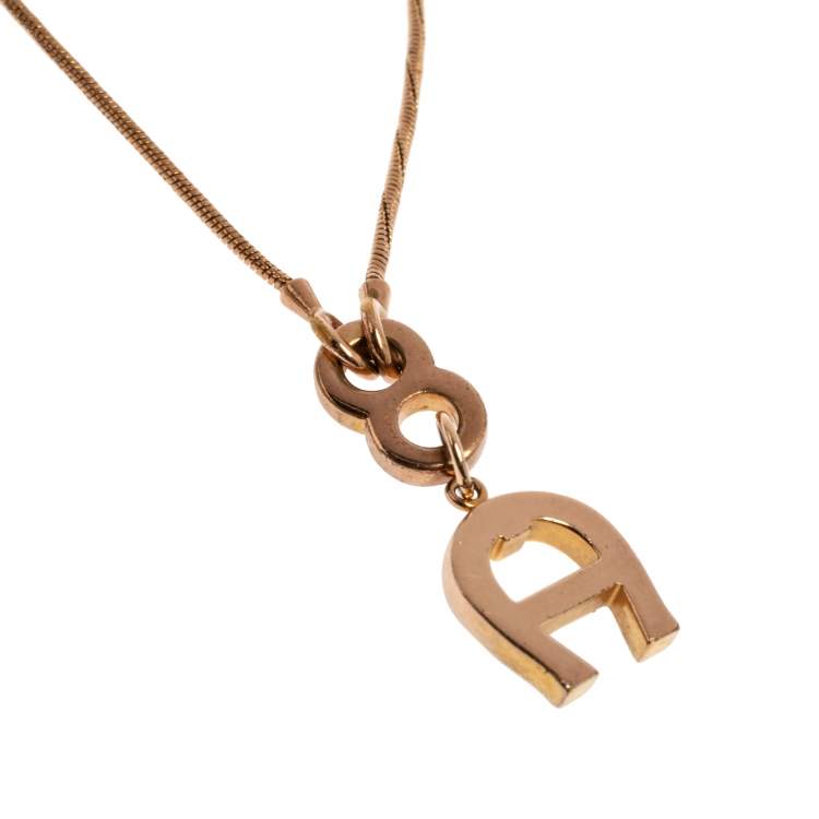 Pre Owned Aigner Gold Tone Crystal Logo Pendant Necklace