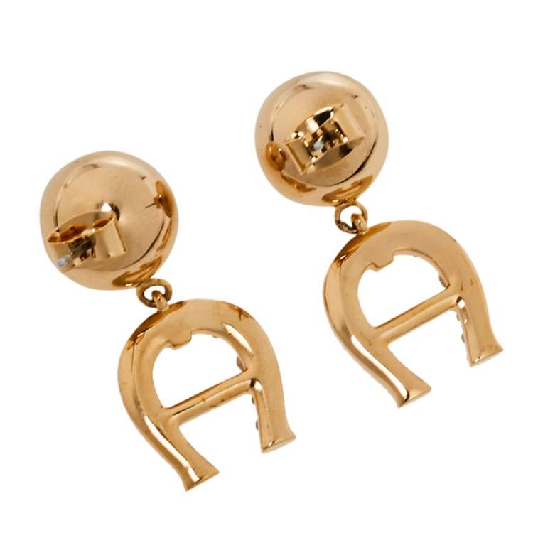 Pre Owned Aigner Gold Tone Layered Bracelet and Logo Drop Earrings Set