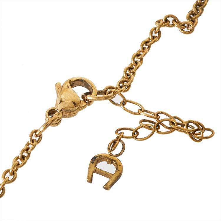 Pre Owned Aigner Gold Tone Mother of Pearl Crystal Logo Pendant Necklace