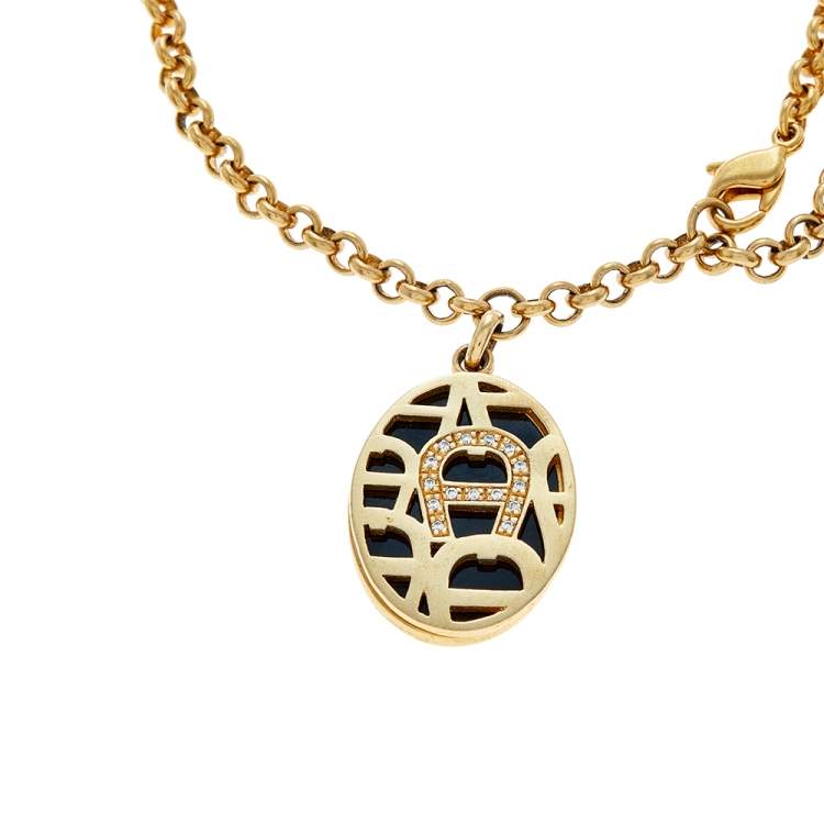 Pre Owned Aigner Gold Tone Enamel & Crystal Logo Charm Bracelet
