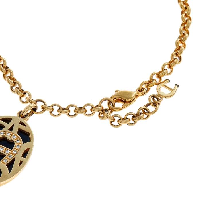 Pre Owned Aigner Gold Tone Enamel & Crystal Logo Charm Bracelet