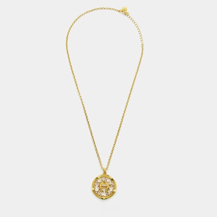 Pre Owned Aigner Gold Tone Crystal Embedded Logo Pendant Necklace & Earrings Set