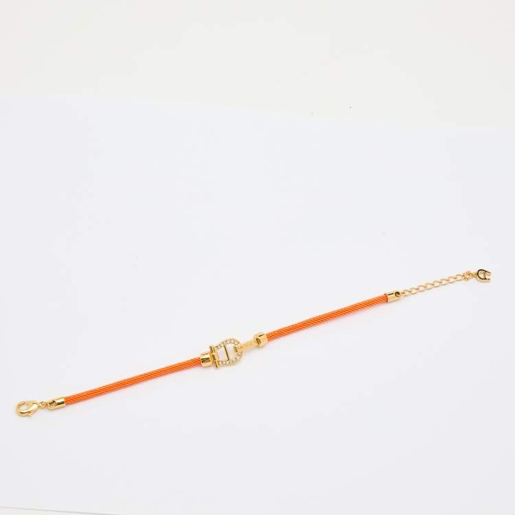Pre Owned Aigner Orange Silk Cord Crystal Logo Yael Bracelet