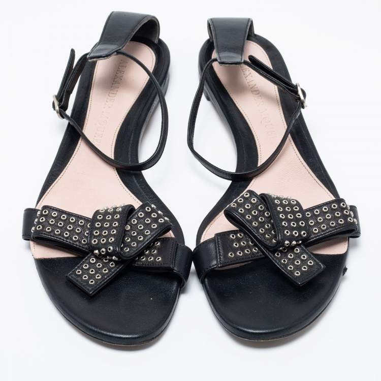 Pre Owned Alexander McQueen Black Leather Eyelet Embellished Bow Flat Ankle Strap Sandals Size 40