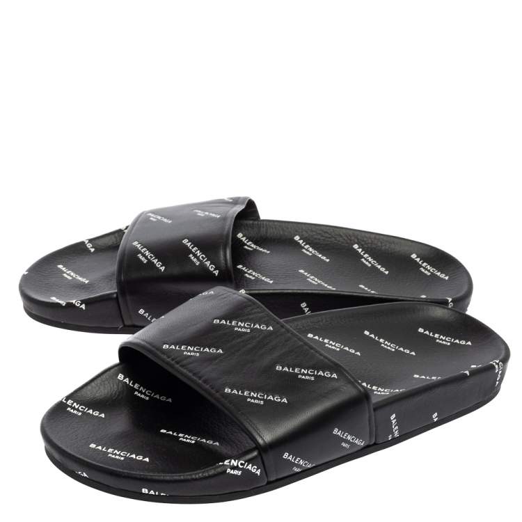 Pre Owned Balenciaga Black All-Over Logo Stamped Leather Flat Slides Size 38