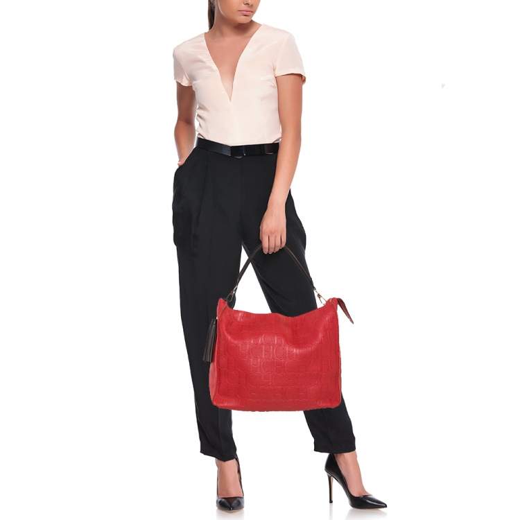 Pre Owned Carolina Herrera Red Monogram Embossed Leather Tassel Hobo