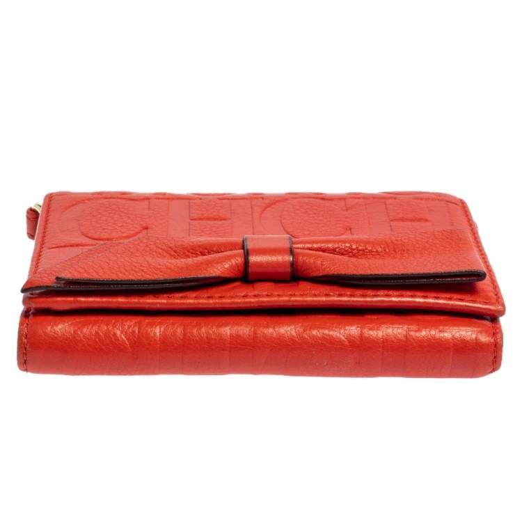 Pre Owned Carolina Herrera Orange Embossed Leather Bow Trifold Wallet