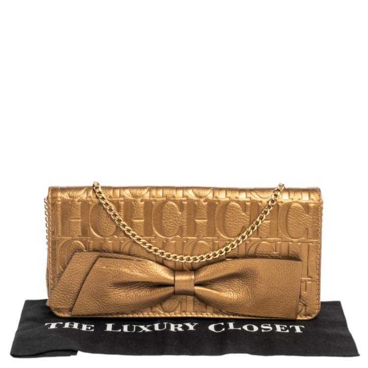Pre Owned Carolina Herrera Gold Monogram Embossed Leather Bow Chain Clutch 
