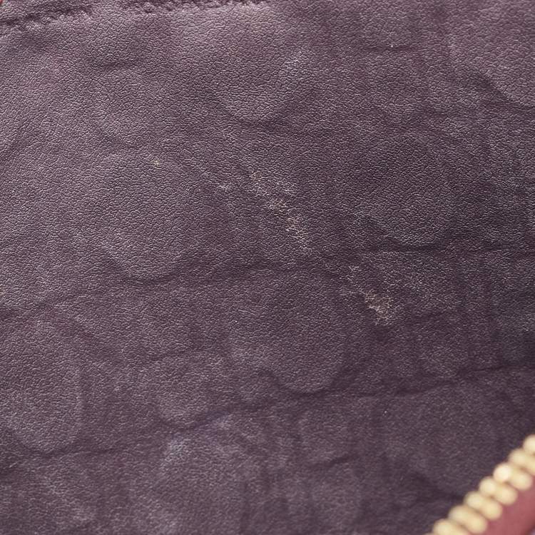 Pre Owned Carolina Herrera Burgundy Monogram Embossed Leather Zip Wristlet Pouch