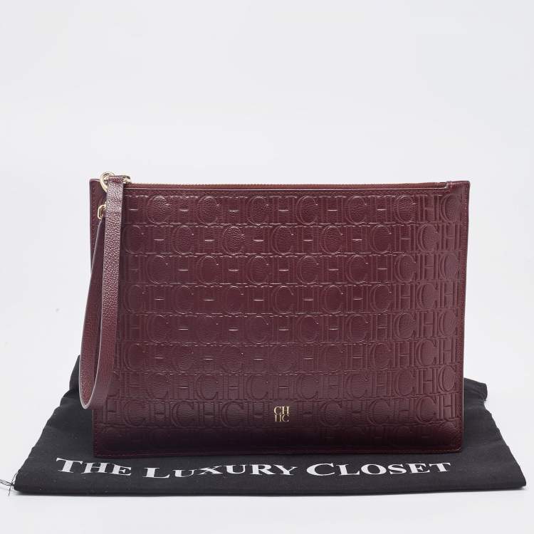 Pre Owned Carolina Herrera Burgundy Monogram Embossed Leather Zip Wristlet Pouch