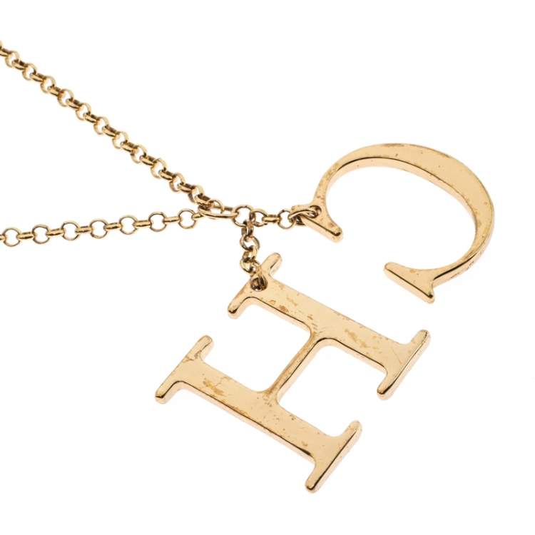 Pre Owned CH Carolina Herrera Logo Charm Gold Tone Long Toggle Pendant Necklace