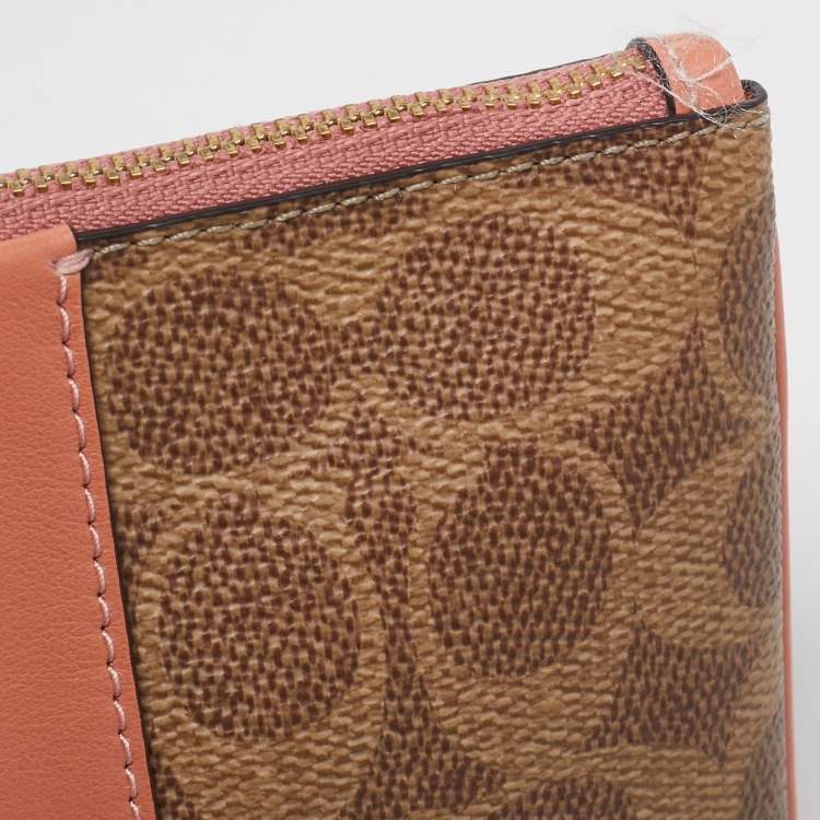 Pre Owned Coach Beige/Peach Signature Coated Canvas and Leather Zip Wristlet Pouch
