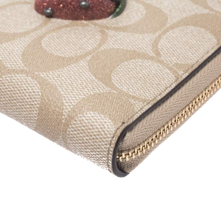 Pre Owned Coach Beige Signature Coated Canvas Strawberry Zip Around Wallet     
